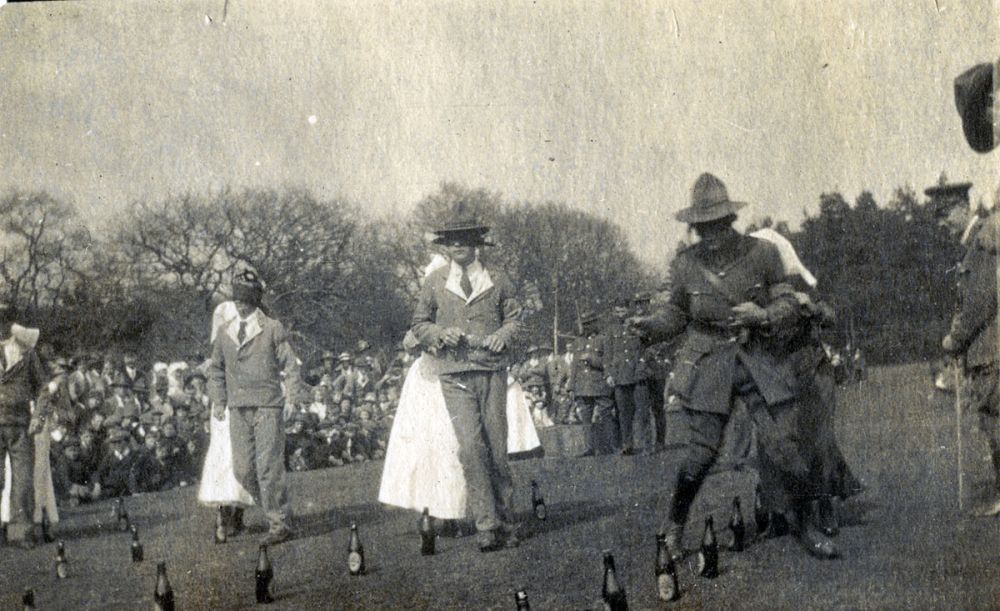 Blindfolded New Zealand soldiers (some patients in hospital uniforms) play a game, guided by nurses, at Anzac Day sports, Brockenhurst.